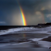 RAINBOW OVER DARK OCEAN