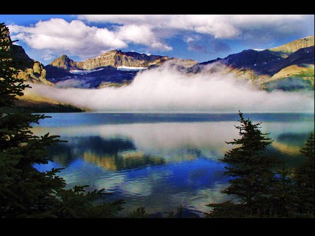 Bed of mist - lake, mountains, reflection, billowing mist, blue sky, trees