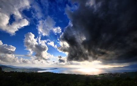 The Storm Approaches - clouds, sunset, town, strom, ocean, reflection, peninsula, bay