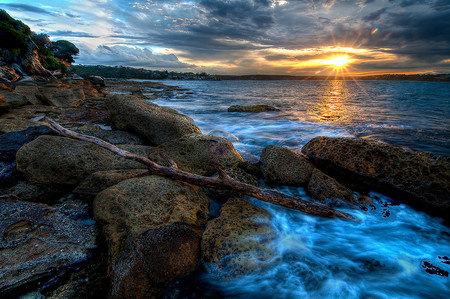 Driftwood at Sunset - sunset, blue water, driftwood, blue skies, rocks, australia