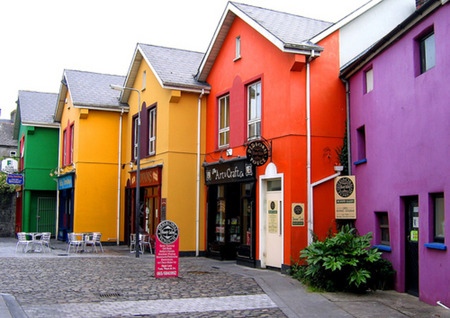 Rainbow Shops - yellow, paving, village, street, colours, purple, red, green, cobblestones