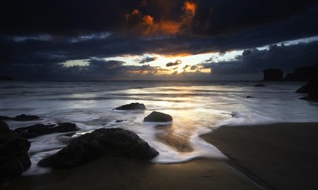 A Touch of Red - clouds, surf, sand, rocks