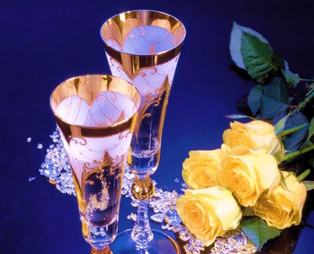 One of life's celebrations - roses, yellow, wine glasses, crystal and gold, celebration