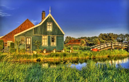 Farmhouse - water, flowers, chimney, yellow trim, bridge, red roofs, milk cans, farm, pond, houses, river, trees, green