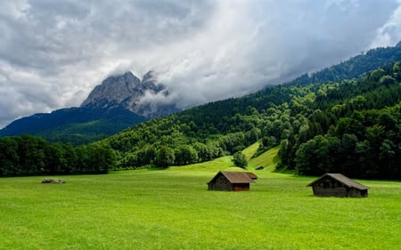 HOUSES AT THE FOOT OF THE MOUNTAIN - clouds, hills, blue, foggy, forest, mountain, green, field, houses