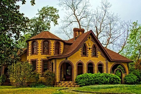 Tennessee home - brown, home, arched windows, brick, trees, hedges, gold