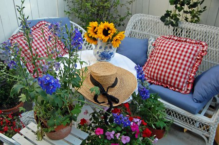 Pretty Little Sun room - flowers, straw hat, pillows, love seat, chair