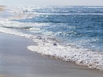 Shimmering Water On The Beach