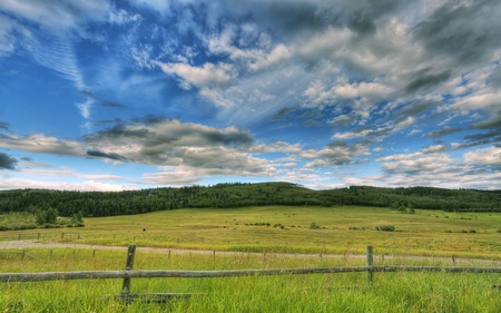 Calgary Foothills - clouds, hills, blue, fields, rolling, beautiful, road, fence, forests, nature, land, hay, farm, sky, bales