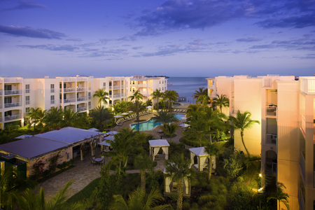 Hotel At Dusk - trees, pool, cabanas, dusk, hotel, ocean