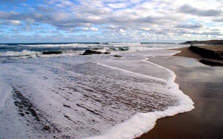 Incoming Tide - beaches, waves, foam, rocks, nature, beautiful, clouds, blue, skies, sand