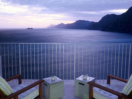 Beyond the blue - hills, blue, tables, chairs, ocean, railing, glasses, balcony, mountains