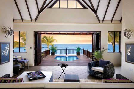 Room with a view - vaulted ceiling, ocean, pillow, sofa, trees, room, sunset, chairs, plants, wicker, view, chair, table, house, pool