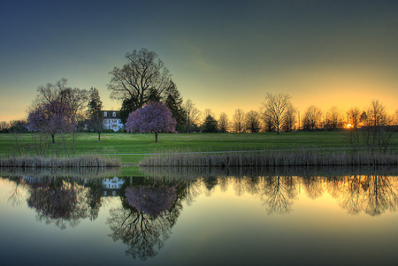 Tranquil Living - house, lush, trees, water, grass, reflection, home, sunset, serenity, lake, country, peaceful