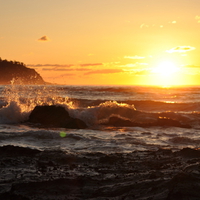 Waves Crashing at Sunrise