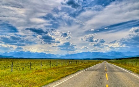 Road to the Rockies - sky, two, field, mountains, nature, rural, beautiful, clouds, blacktop, lane