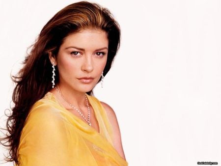 Catherine Zeta-Jones - sexy face, female, yelow dress, long hair, brunette, actress