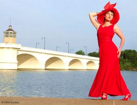 RED DRESSED BEAUTY NEAR OCEAN  BRIDGE - beauty, woman, red dress, hat, water, bridge