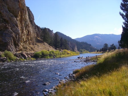 Being one with nature - sky, person, river, blue, grass, rocks