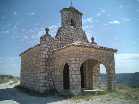 Chapel overlooking Pastrana - height, blue sky, entrance, white chapel, stones