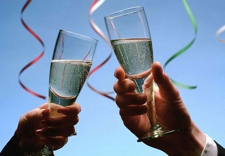 Time to celebrate - hands, happy new year, ribbons, wineglasses, wine, bubbles, bubbly