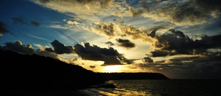 South Welsh Coast, Wales UK - blue, rock, sea, silhouette, dark clouds, sun