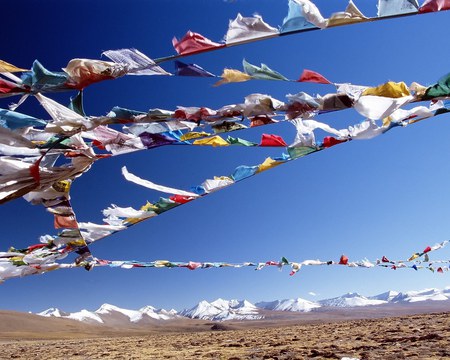 Flags in Tibet - mountains, white, flying, prayer, colour, flag, symbol, yellow, red, blue, snow, green, breeze, desolate, earth