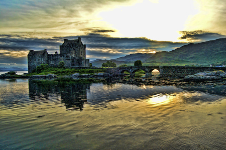 Eileen Doonan Castle - walls, sunlight, mountain, yellow, castle, towers, refelection, waves