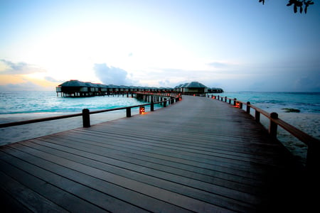 Pier to The Sea - pier, sunset, huts, sea, lights