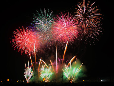 Celebration of Fireworks - display, colour, light, orange, celebrate, silver, red, green, brilliance, sparks, smoke, pyrotechnic, noise