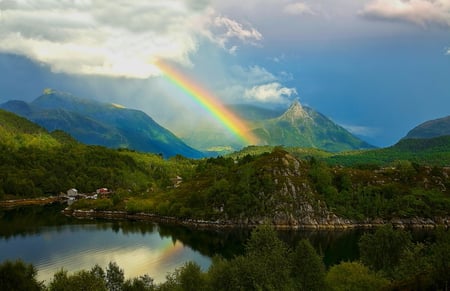 The Rainbow - see, sky, houses, rainbow, greens, mountains, rocks, white, reflection, blue, beautiful, clouds