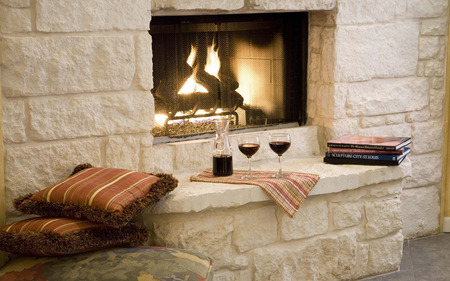 fireplace - calm, romantic, room, pillows, romance, books, comfortable, style, wine, fireplace, fire, nice, stonework, stone, beautiful, decor, cushions, photography, placemat, cool, architecture, drink, glasses, design, carafe, peaceful, glass