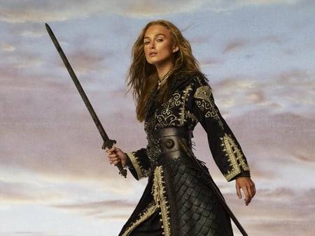 Keira Knightley - blondie, female, warrior woman customs, sword, long hair, actress, nice dress