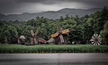 Windmills - clouds, trees, water, grass, windmills, popular, arhitecture, forests, grey, green, mountains, sky