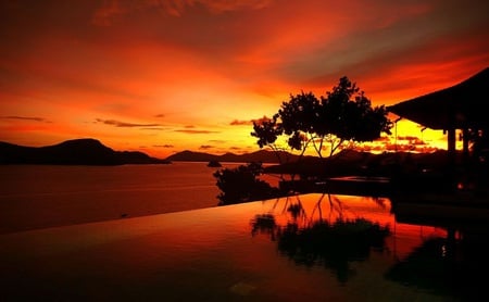 Reflective sunset - reflections, villa, sunset, pool, sea, orange, mountains, tree