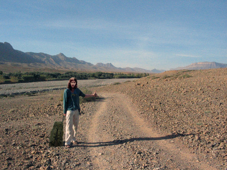 Going my way - dirt, woman, mountains, road