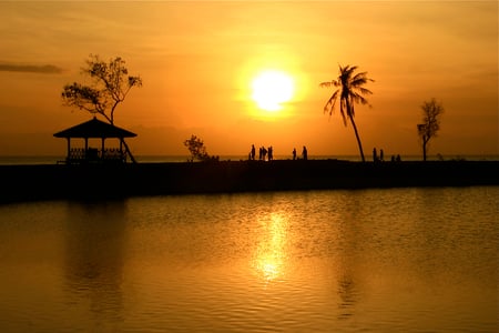 Golden Sunset - beauty, sky, trees, people, golden sunset, peaceful, sun, sunset, gazebo, reflection, evening, clouds, golden, ocean, lovely, nature, beautiful, sea