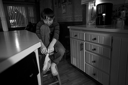 Putting on a sock - table, kitchen, boy, other