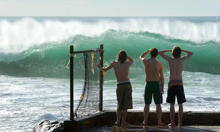 Watching the big wave - three, beach, watch, boys, men, wave, watching, nature, swimsuites, guys