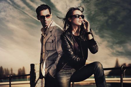 Attractive young couple - clouds, windy, beautiful, evening, portrait, fashion, photoshoot, beauty, attractive, elegance, female model, pose, couple, male model, young, sunglasses