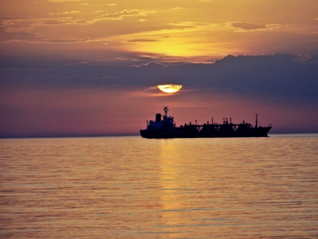 ship in a sunset - see, ship, clouds, sun, sunset, birds, waves