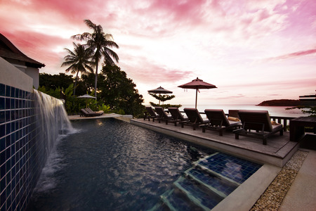 Beautiful View - relax, swimming pool, chairs, grass, holiday, view, paradise, sky, clouds, house, palms, trees, water, beautiful, sea, beauty, colors, resort, lovely, ocean, stones, chair, colorful, stairs, nature, sunset, tropical, pool, green, deck, peaceful, umbrellas