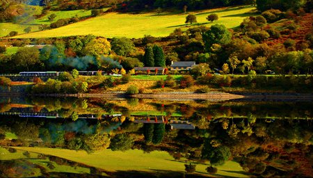 Reflection - hills, cars, sunny, splendor, landscape, grass, reflection, train, view, railway, lake, houses, house, trees, train station, water, beautiful, road, beauty, colors, lovely, architecture, fall, nature, green, autumn, peaceful