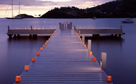 Dinner with a view - beautiful, evening, chairs, table, sea, ocean, dock, boats, dinner, fire, flames, candles, deck, lake, dusk, mountains