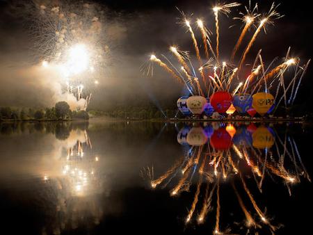 Fireworks and air-balloons! - hot air balloons, air, festival, night, photo, reflection, festive, fireworks, sky, nightscene, trees, water, image, photograph, colours, picture, lights, balloons, wall, wallpaper