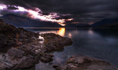 Beautiful Sunset - rocks, beautiful, sundown, amazing, purple sunset, view, nature, sunset, stormy, mountains, purple, end, water, mirrored, beauty, stones, dark, peaceful, lake, sky, dusk, storm, reflection, sunlight, clouds, lovely, splendor, colors, sunrise, day