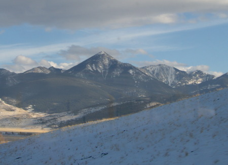 In our travels through the great state of Montana - winter, blue sky, and grey cloud cover, mountain