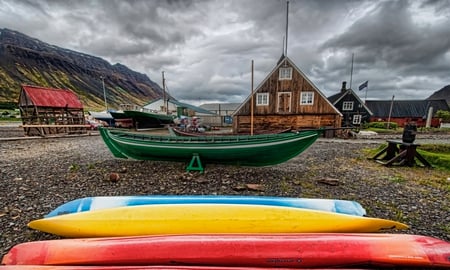 Beautiful Place - yellow, blue, boat, grass, car, view, red, houses, sky, flag, storm, clouds, house, beautiful, stormy, beauty, colors, lovely, architecture, stones, boats, colorful, nature, green, peaceful