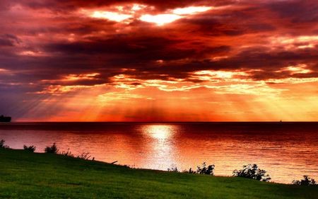 Amazing Sky - beautiful, amazing, ocean, grass, view, nature, sunset, red, rays, beauty, peaceful, sky, reflection, sunlight, clouds, lovely, splendor, red sunset, sea, colors, green