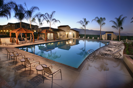 Serene pool - reflections, tables, lounges, cabanas, chairs, sunchairs, buildings, tiles, pool, lights, palm trees, mountains